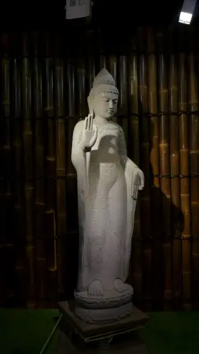 Product image of the product “Standing Buddha with floral carving, Abudaya position. 43 x 39 x 175cm. Natural stone (river stone), stonemasonry ”